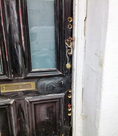 A door left full of drill holes