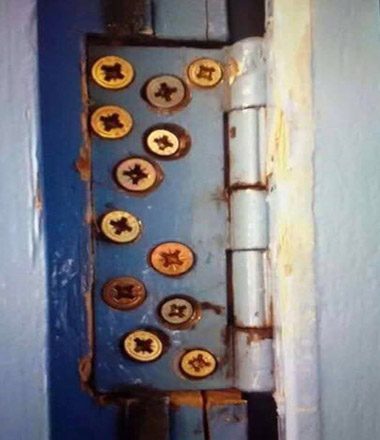 A hinge packed with far too many screws