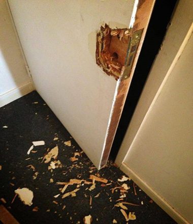 A door smashed open around the lock